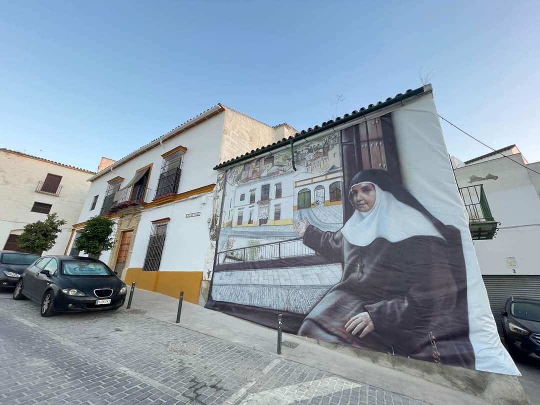 Santa Ángela, en la puerta de su convento